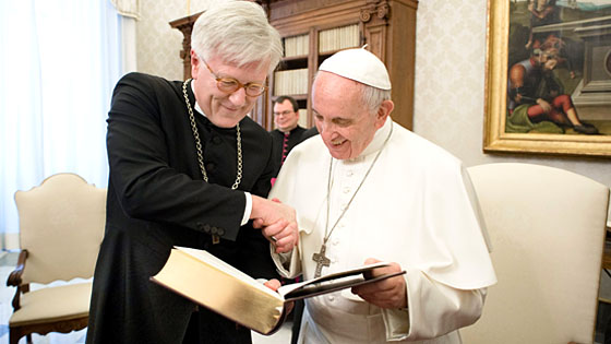 Heinrich Bedford-Strohm berreicht Papst Franziskus eine Lutherbibel. (Foto: Agenzia Romano Siciliani/ L'Osservatore Romano)